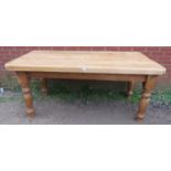 A substantial stripped pine farmhouse kitchen table, on baluster turned supports. H80 W182 D89 (