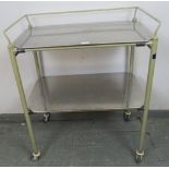 A vintage steel two-tier medical trolley with removable brushed steel shelves, on steel and rubber