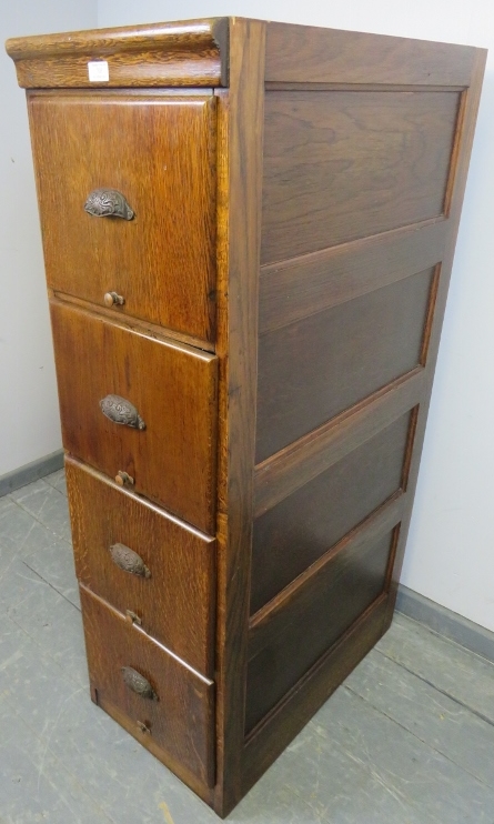 An early 20th century oak filing cabinet with fielded side panels, housing four drawers with cast - Image 2 of 3