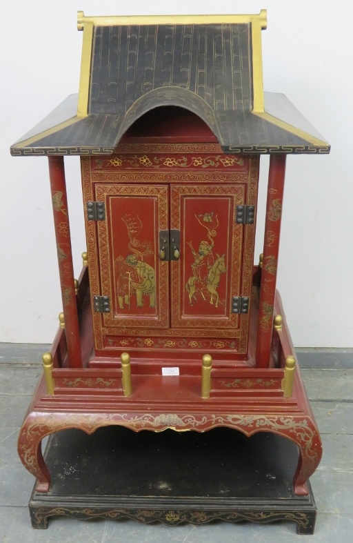 A vintage Chinese temple cabinet, the red lacquer hand painted with traditional scenes and gold