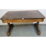 A William IV rosewood library table with two short drawers and two dummy drawers, on scrolled