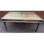 An antique tropical hardwood Thakat dining table, with cast iron studs and cast iron strapwork