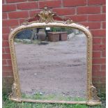 A Victorian arched overmantel mirror with moulded cornice and pierced fretwork detail to corners,