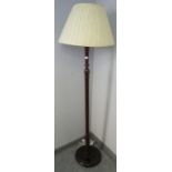 A vintage mahogany standard lamp with reeded column over a circular plinth base. Includes pleated