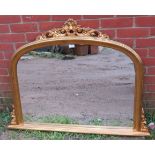 A 19th century style arched overmantel mirror in a gilt frame with moulded cornice and corner detail