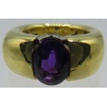 A heavy 18ct yellow gold ring set with centre amethyst, approx 10mm x 8mm. To the top of the ring is