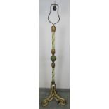 An ornate metal standard lamp in the Florentine taste, with painted rope twist column and gilt