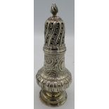 A mid 19th century silver sugar caster with hunting and embossed scrolls and flowers. Hallmarks