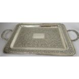 A fine white metal Indian tray with embossed foliate design. Approx: 17" x 12" excluding carrying