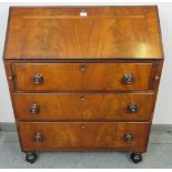 An early Victorian flame mahogany bureau, with crossbanded inlay, the fall front opening onto a