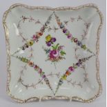 A hand decorated German porcelain dish in the Meissen style, blue crossed swords mark to base.