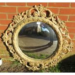 A large convex wall mirror with ornate gesso surround in the Florentine taste, depicting a multitude