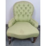 A Victorian bedroom chair, reupholstered in green buttoned material, on tapering walnut supports