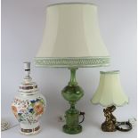 An elegant green marble table lamp in the classical style, a gilt metal cherub lamp and a pottery