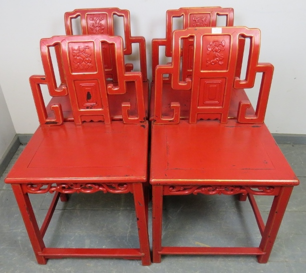 A set of four early 20th century Chinese cinnabar dining chairs in red lacquer with gold accents,