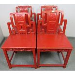 A set of four early 20th century Chinese cinnabar dining chairs in red lacquer with gold accents,