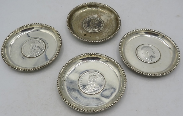 A set of 4 small circular silver dishes inset with one Rupee coins. 1907, 1917 and 1919. 2 troy oz/