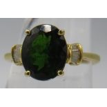 Russian diopside solitaire with baguette diamond inset solitaires, size Q. Oval faceted diopside