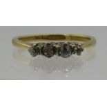 An 18ct yellow gold set ring with four small diamonds, size J. Approx 2.1gms. Condition report: Sur