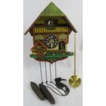 A mid century German cuckoo clock with moving figures. Needs restoration. Condition report: