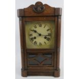 An early 20th century oak cased striking mantel clock with pendulum and key. Height 38cm.