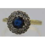 An 18ct yellow gold platinum cluster ring set with centre sapphire, approx 5mm x 5mm, surrounded