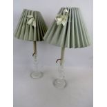 A pair of cut glass candlesticks, adapted to table lamps, with shades, glass section 25cm high.