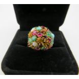 A 'Retro' yellow metal multi stone cluster ring set with rubies, emeralds, amethyst and many more,