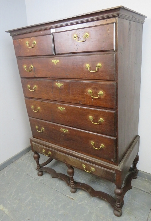 An 18th century oak chest on stand, housing two short over three long drawers with brass batwing - Image 2 of 4