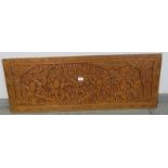 A vintage African teak wall-mounted frieze panel, with relief carving depicting figural motifs.
