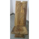 A vintage African hardwood birthing stool, with relief carving depicting a tribal figure. H75 W30