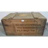 An antique wine crate stencilled ‘Hicks & company wine merchants, Plymouth’ with braided rope