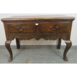 An early 18th century oak sideboard strung with satinwood and ebony, housing two short drawers