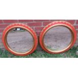 A pair of good decorative vintage circular wall mirrors in red lacquer and parcel gilt surrounds.