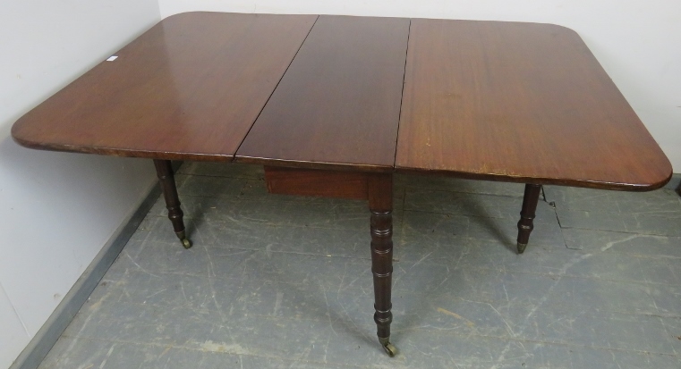 An early Victorian mahogany drop-leaf dining table, on tapering turned supports with brass caps - Image 3 of 4