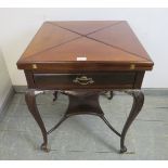 An Edwardian Georgian Revival mahogany envelope card table, the drawer with ormolu handles, on