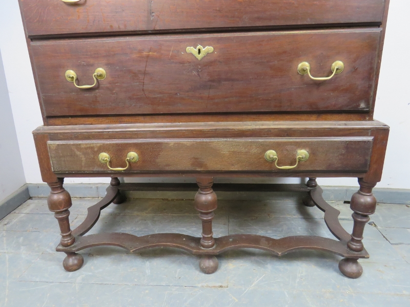 An 18th century oak chest on stand, housing two short over three long drawers with brass batwing - Image 4 of 4