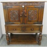 A vintage oak court cupboard of small proportions in the 16th century taste, with carved frieze