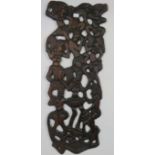 A vintage African hardwood carved and pierced wall-mounted panel, depicting figural motifs. H118cm