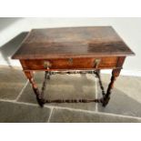 An early 18c Country oak side table (1740 ) with a long frieze drawer and brass drop handles and