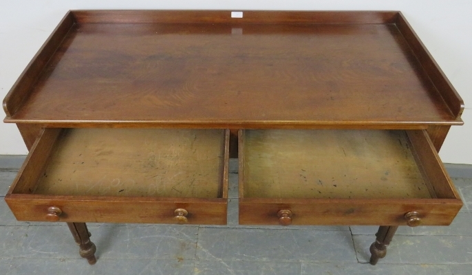 A Victorian mahogany writing table, with 3/4 gallery, housing two short drawers with turned wooden - Image 3 of 3
