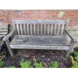 A vintage weathered teak slatted garden bench, on square supports. H90cm W154cm D64cm (approx).