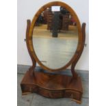 An Edwardian Regency Revival mahogany oval swing mirror, strung with satinwood, above a serpentine