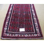 A good Hoseinabad small runner in very good condition. Repeat central pattern on claret field. 190cm