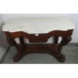 A Victorian mahogany console table, with a white marble shaped top, above a central blind drawer, on