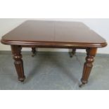 A Victorian mahogany wind-out extending dining table, with additional leaf, on tapering fluted