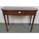 A George III mahogany turnover card table, with reeded edge, on tapering turned supports. H71cm