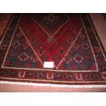 A Persian Meimeh rug diamond motif on blue/red field in very clean condition. 200cm x 134cm.