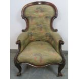 A Victorian mahogany show-wood armchair, featuring carved acanthus scrolls, upholstered in golfing
