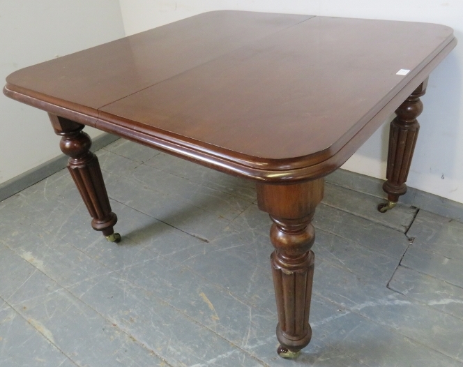 A Victorian mahogany wind-out extending dining table, with additional leaf, on tapering fluted - Image 2 of 4